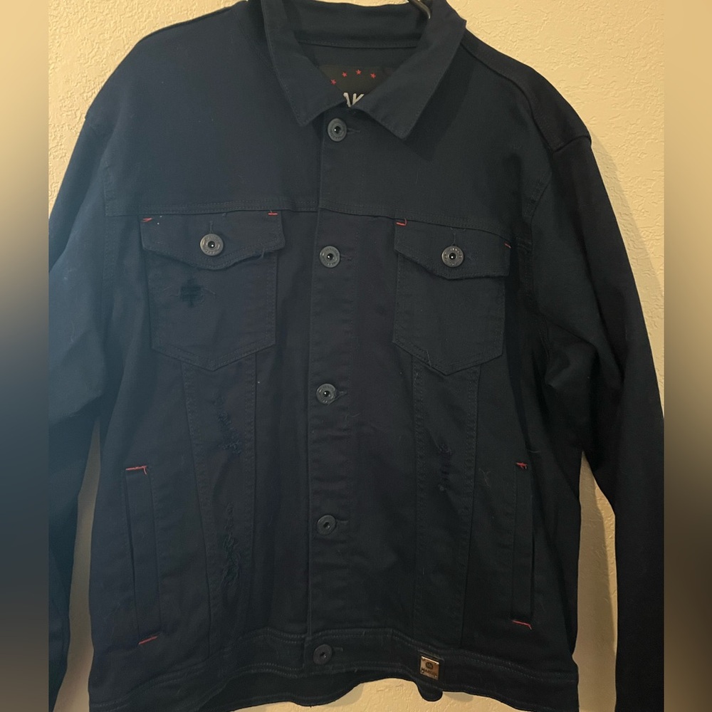 A 2x dark blue denim jacket by the brand MAKOBI